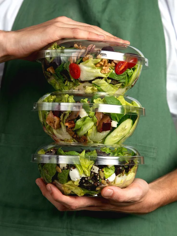 Stacked salad bowls — prescribed nutrition in practice.